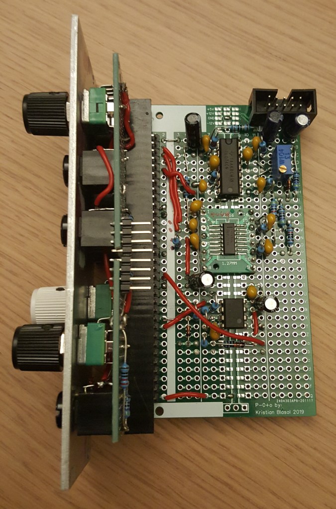 Prototype module, side-view showing top of prototype board with components. One of the ICs is a small surface-mount component soldered to an adaptor board. A few jumper cables criss-cross around the board, but generally the layout is dense and tidy.